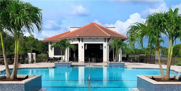 a view of a house with swimming pool and sitting area