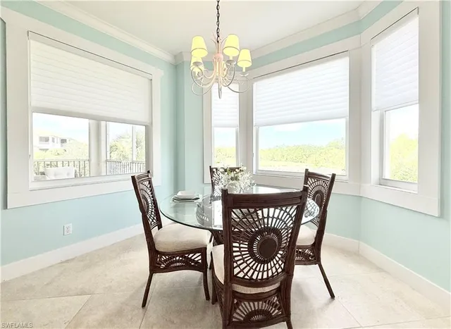 a view of a dining room with furniture a chandelier and wooden floor