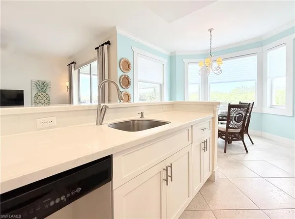 a kitchen with a sink cabinets and window