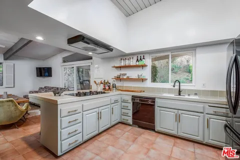a kitchen with a sink stove and cabinets