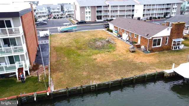 an aerial view of residential houses with outdoor space and swimming pool