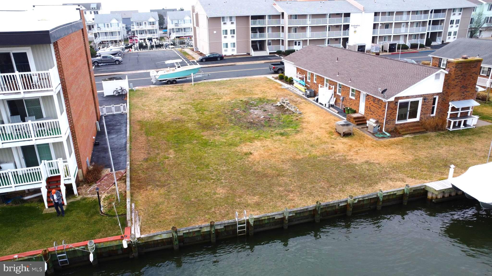 an aerial view of residential houses with outdoor space and swimming pool