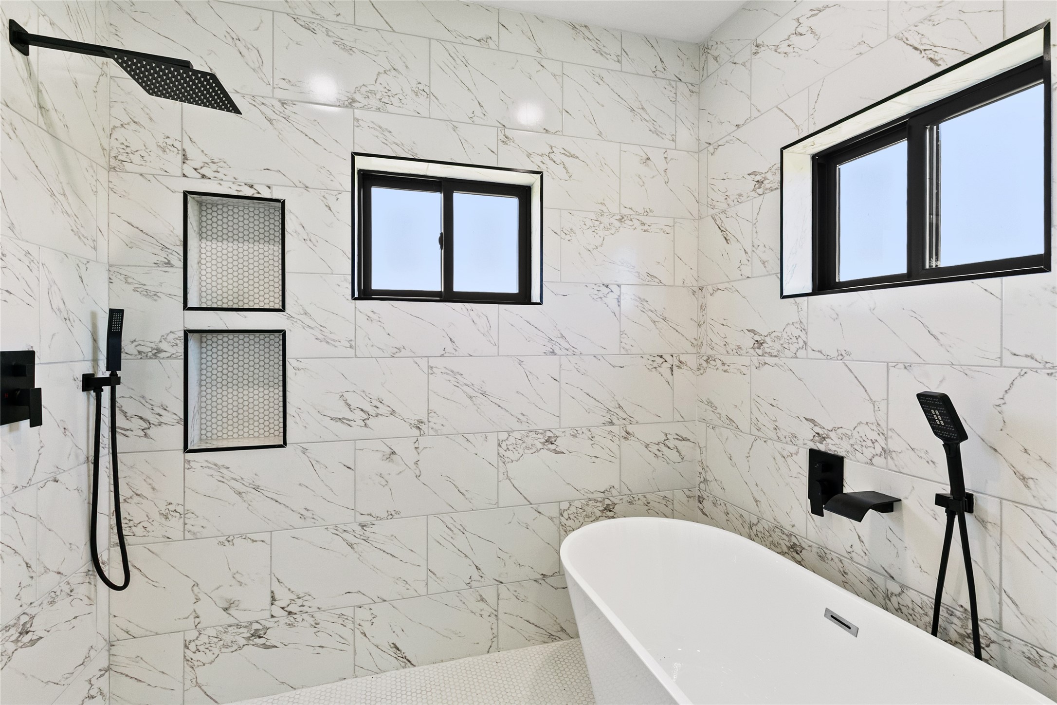 619 Chuckwagon Trail Angleton, TX 77515 - Photo 22 of 37 A stunning wet room serves as the centerpiece of the primary bath, combining a freestanding soaking tub and dual-head shower within a beautifully tiled space.