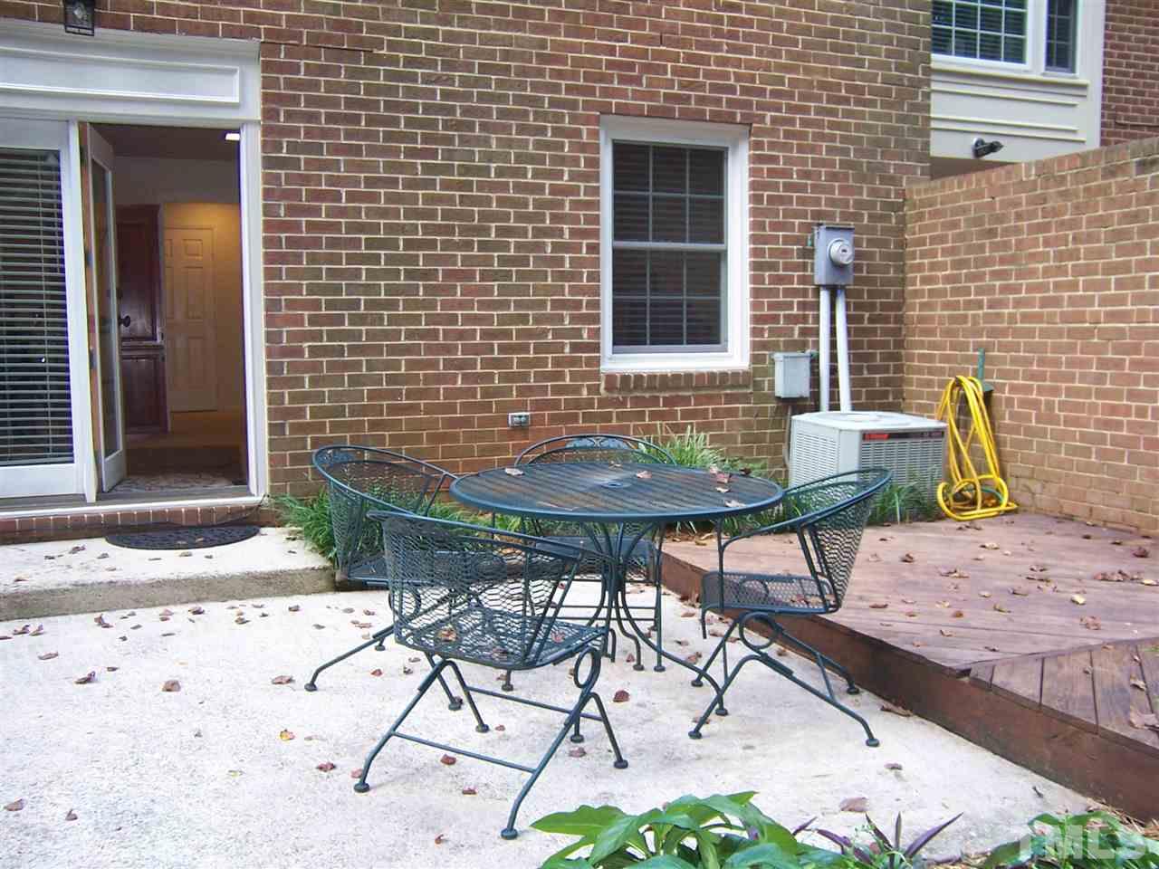 2834 Wycliff Road Raleigh, NC 27607 - Photo 22 of 25 a patio with table and chairs and potted plants