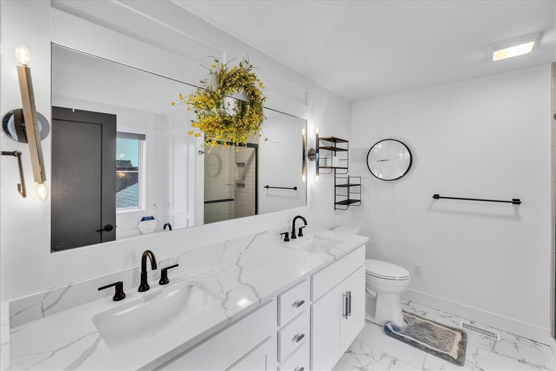 908 Declaration Drive Savoy, IL 61874 - Photo 27 of 41 a bathroom with a double vanity sink and a mirror