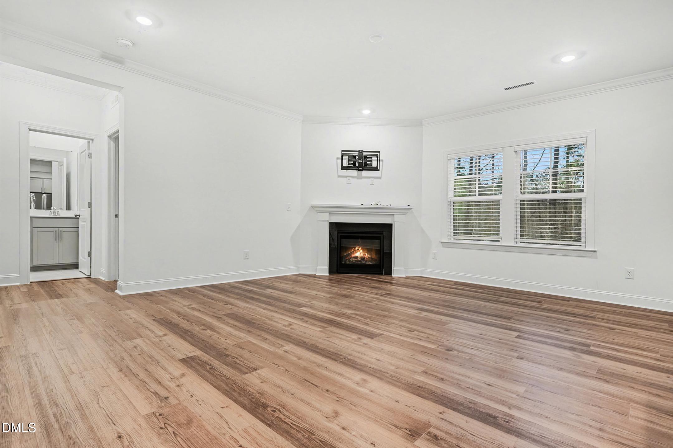 1328 Hazelnut Ridge Lane Knightdale, NC 27545 - Photo 11 of 50 a view of empty room with wooden floor and fireplace