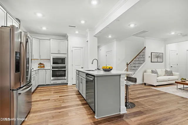 a kitchen with stainless steel appliances a stove top oven and refrigerator