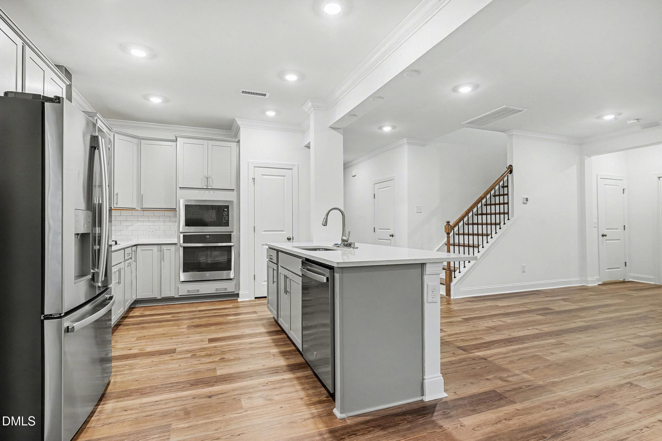 1328 Hazelnut Ridge Lane Knightdale, NC 27545 - Photo 16 of 50 a kitchen with stainless steel appliances a refrigerator and a stove top oven