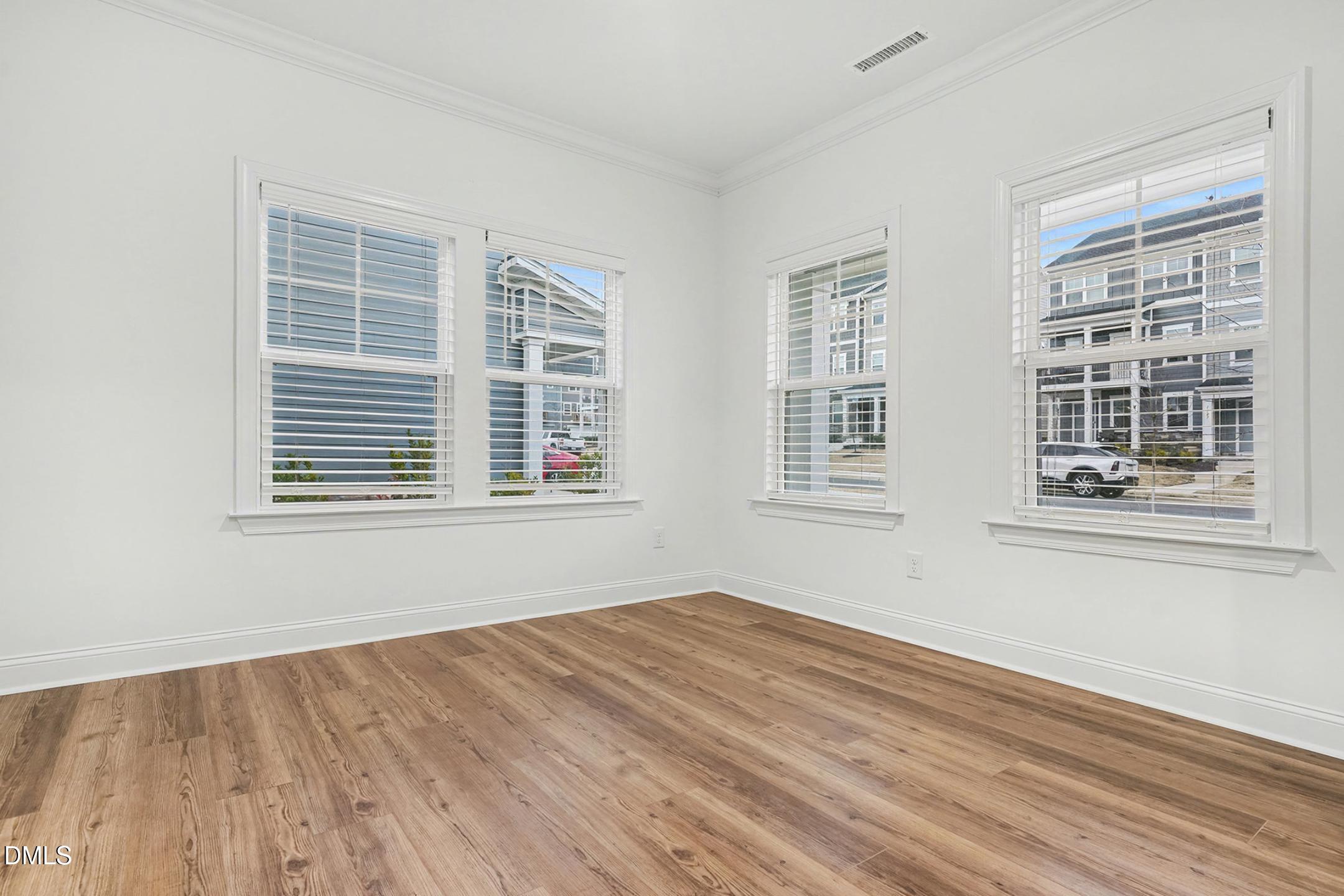 1328 Hazelnut Ridge Lane Knightdale, NC 27545 - Photo 18 of 50 a view of empty room with wooden floor and fan