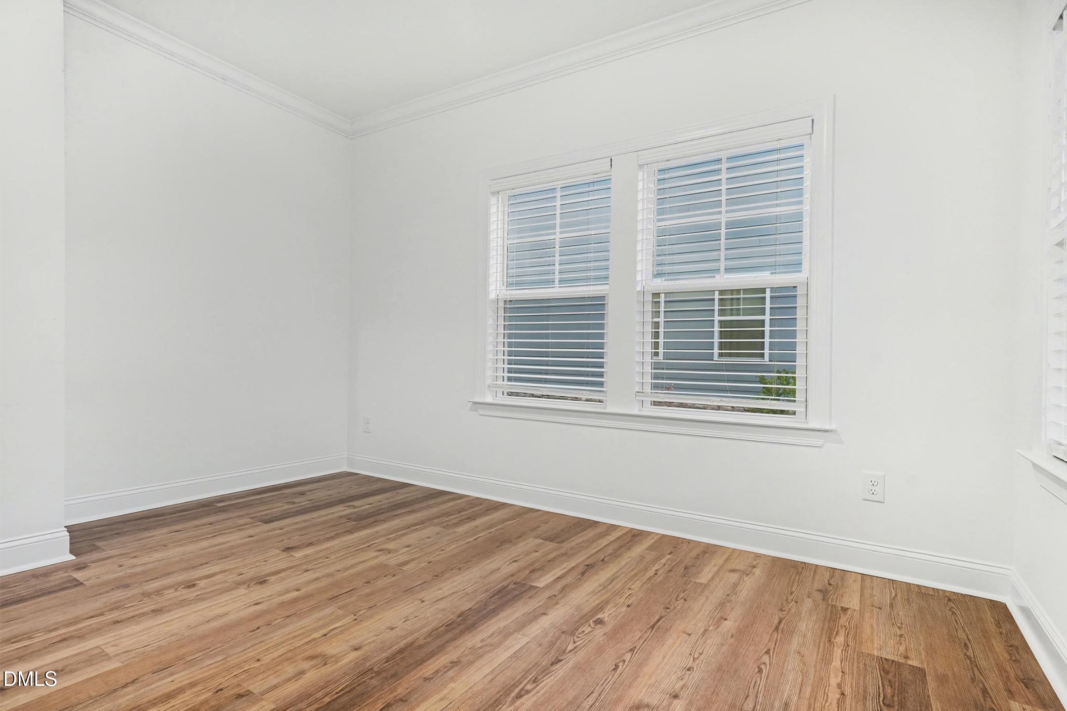 1328 Hazelnut Ridge Lane Knightdale, NC 27545 - Photo 19 of 50 a view of a room with wooden floor and windows