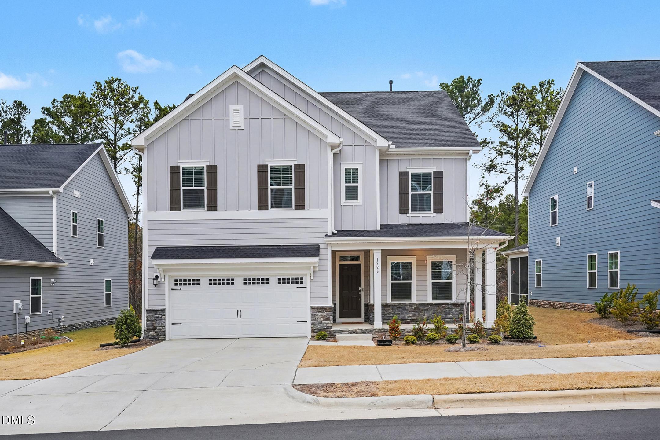 1328 Hazelnut Ridge Lane Knightdale, NC 27545 - Photo 2 of 50 a front view of a house with a yard