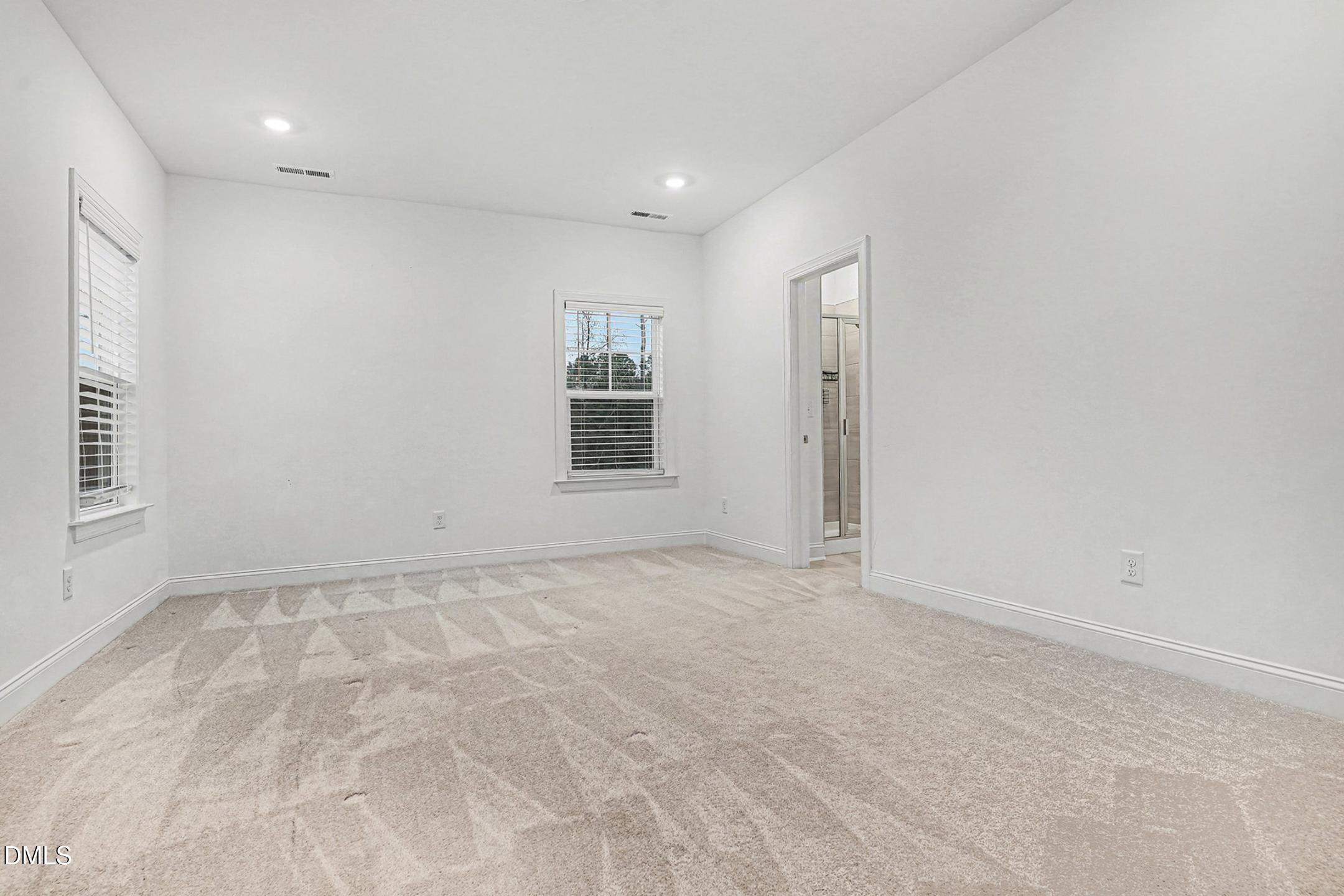 1328 Hazelnut Ridge Lane Knightdale, NC 27545 - Photo 22 of 50 an empty room with windows