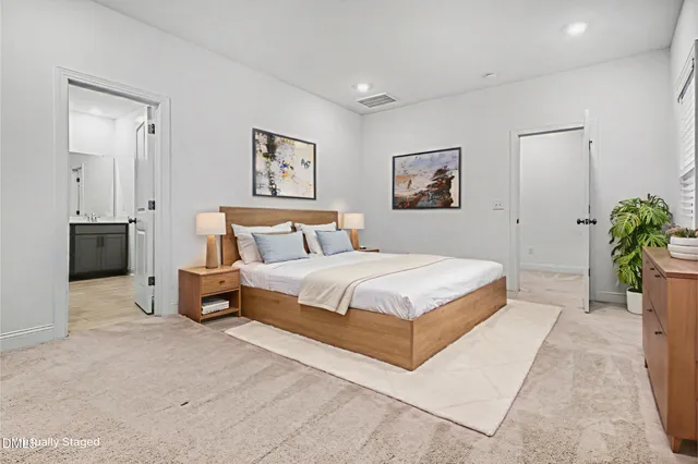 a bedroom with a bed and a painting on the wall