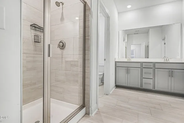 a bathroom with a tub shower sink and mirror