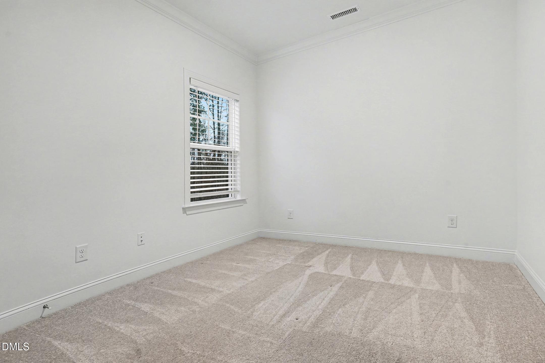 1328 Hazelnut Ridge Lane Knightdale, NC 27545 - Photo 29 of 50 a view of an empty room with a window