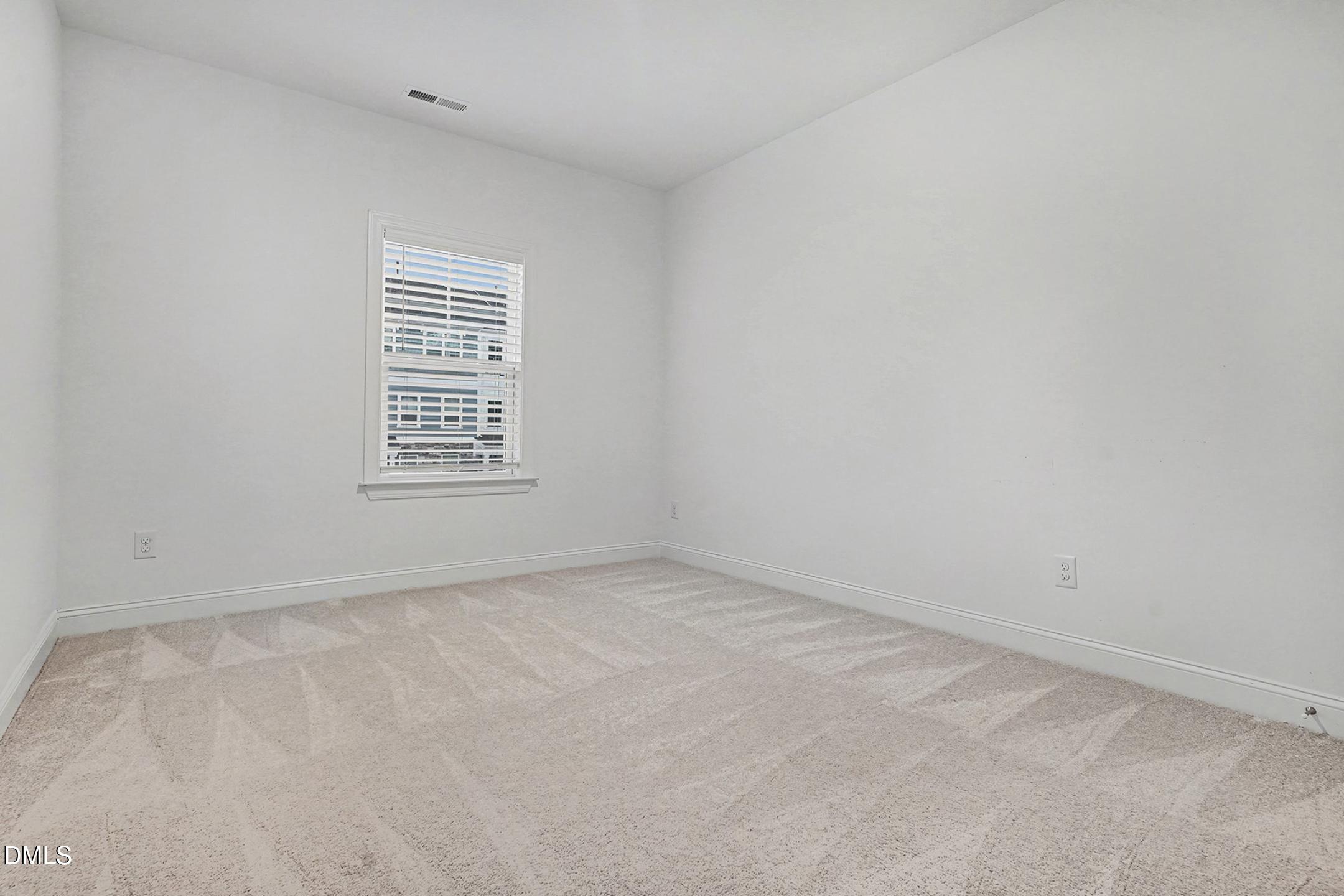 1328 Hazelnut Ridge Lane Knightdale, NC 27545 - Photo 32 of 50 an empty room with a window