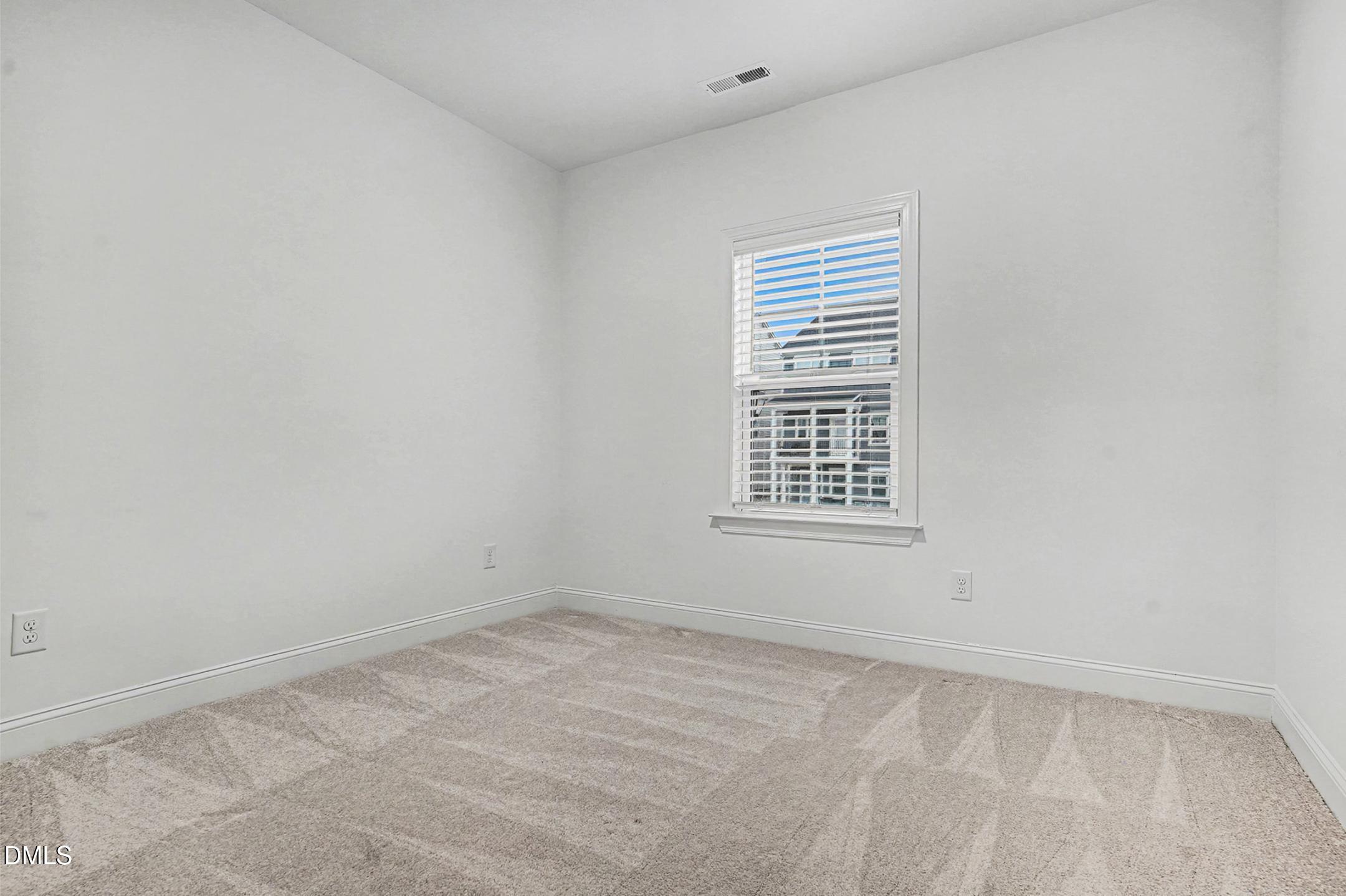 1328 Hazelnut Ridge Lane Knightdale, NC 27545 - Photo 36 of 50 an empty room with a window