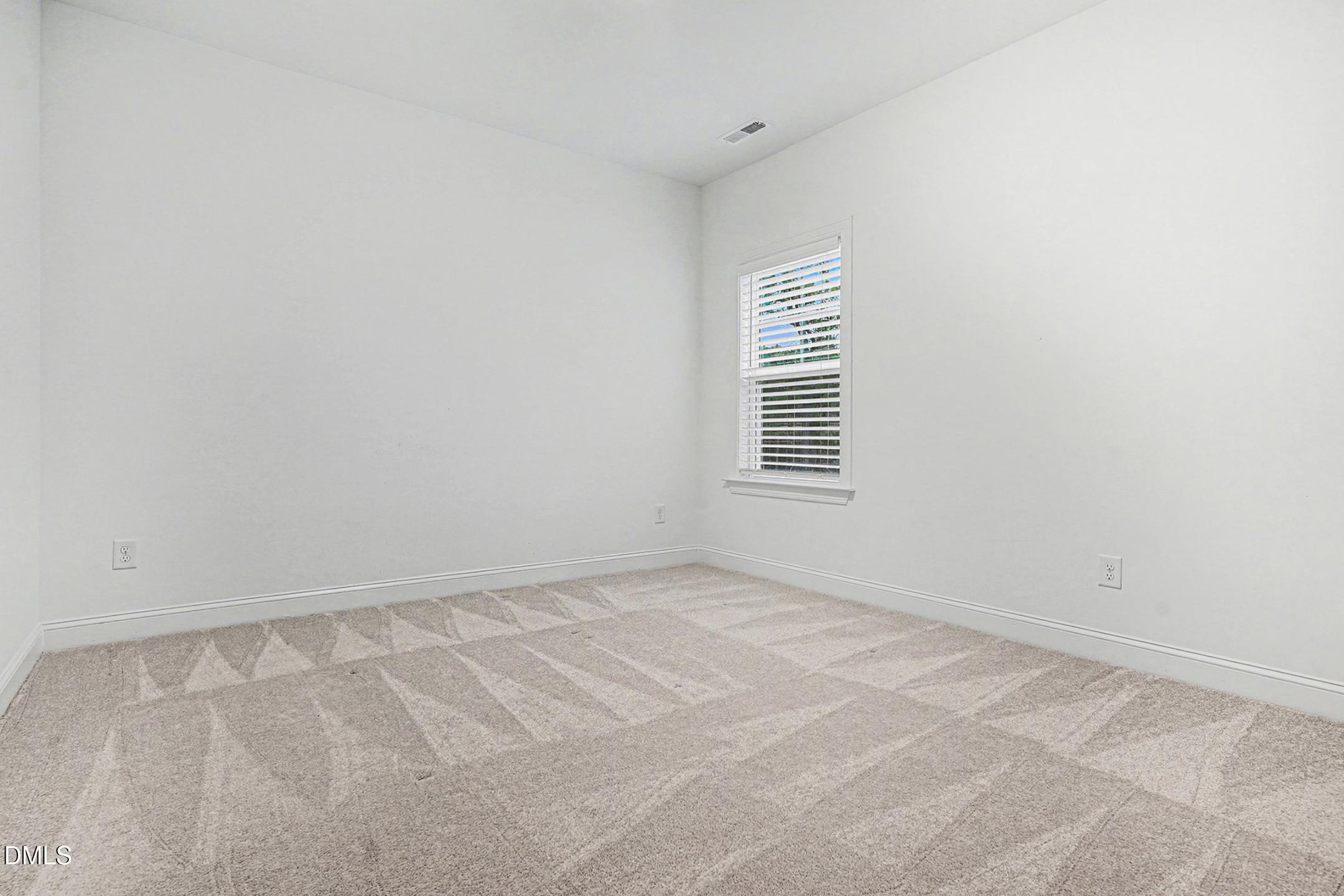 1328 Hazelnut Ridge Lane Knightdale, NC 27545 - Photo 38 of 50 an empty room with windows