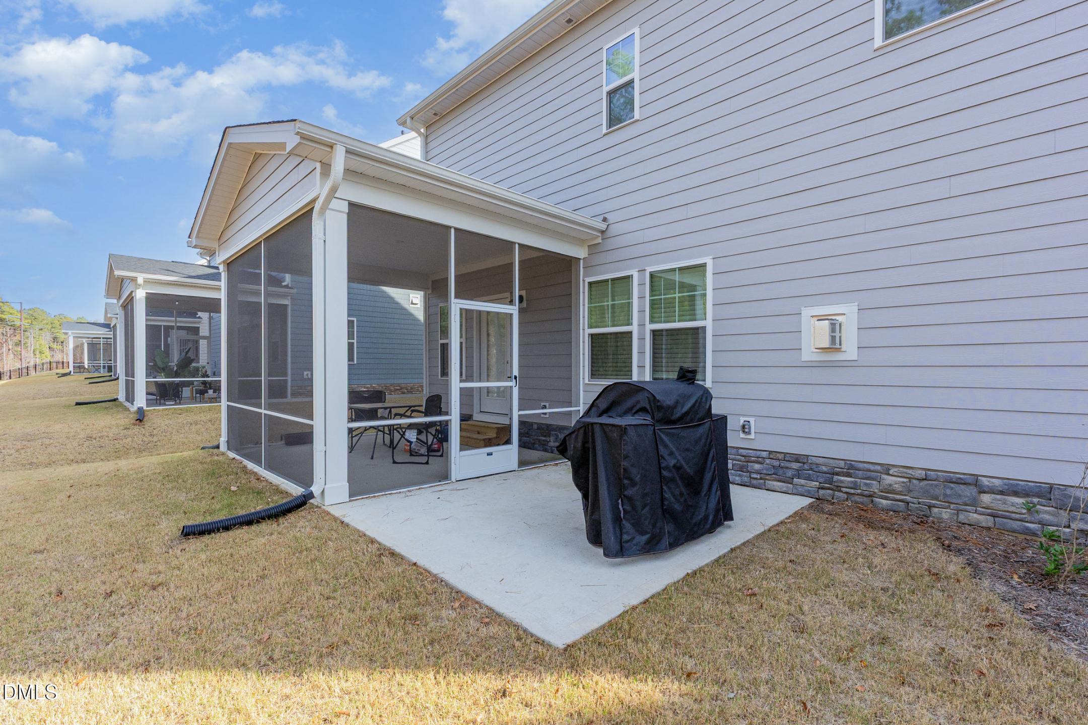 1328 Hazelnut Ridge Lane Knightdale, NC 27545 - Photo 46 of 50 a view of a house with a barbeque and wooden stairs