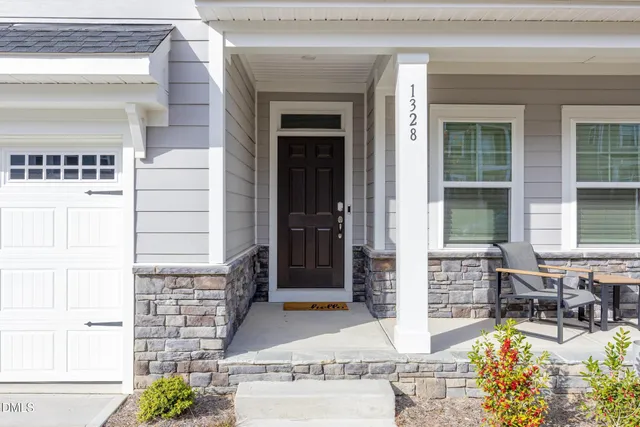 a view of front door of house with outdoor seating