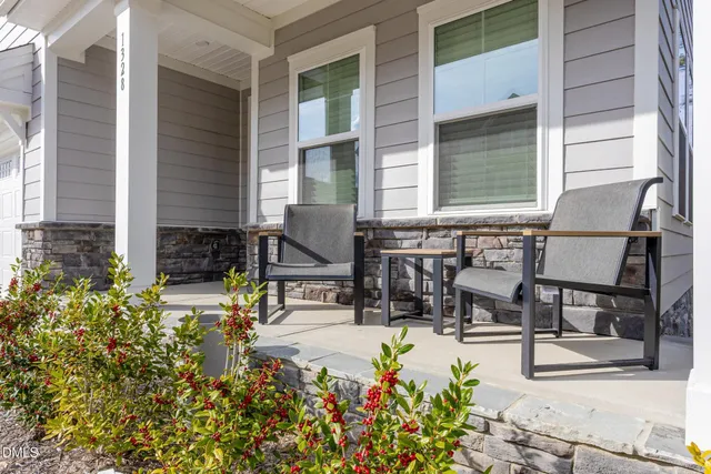 a view of a patio with table and chairs and potted plants