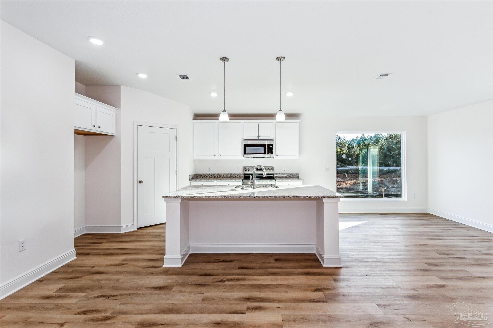 4613 Carl Booker Road Milton, FL 32583 - Photo 11 of 26 a view of kitchen with granite countertop stainless steel appliances stove a sink and dishwasher