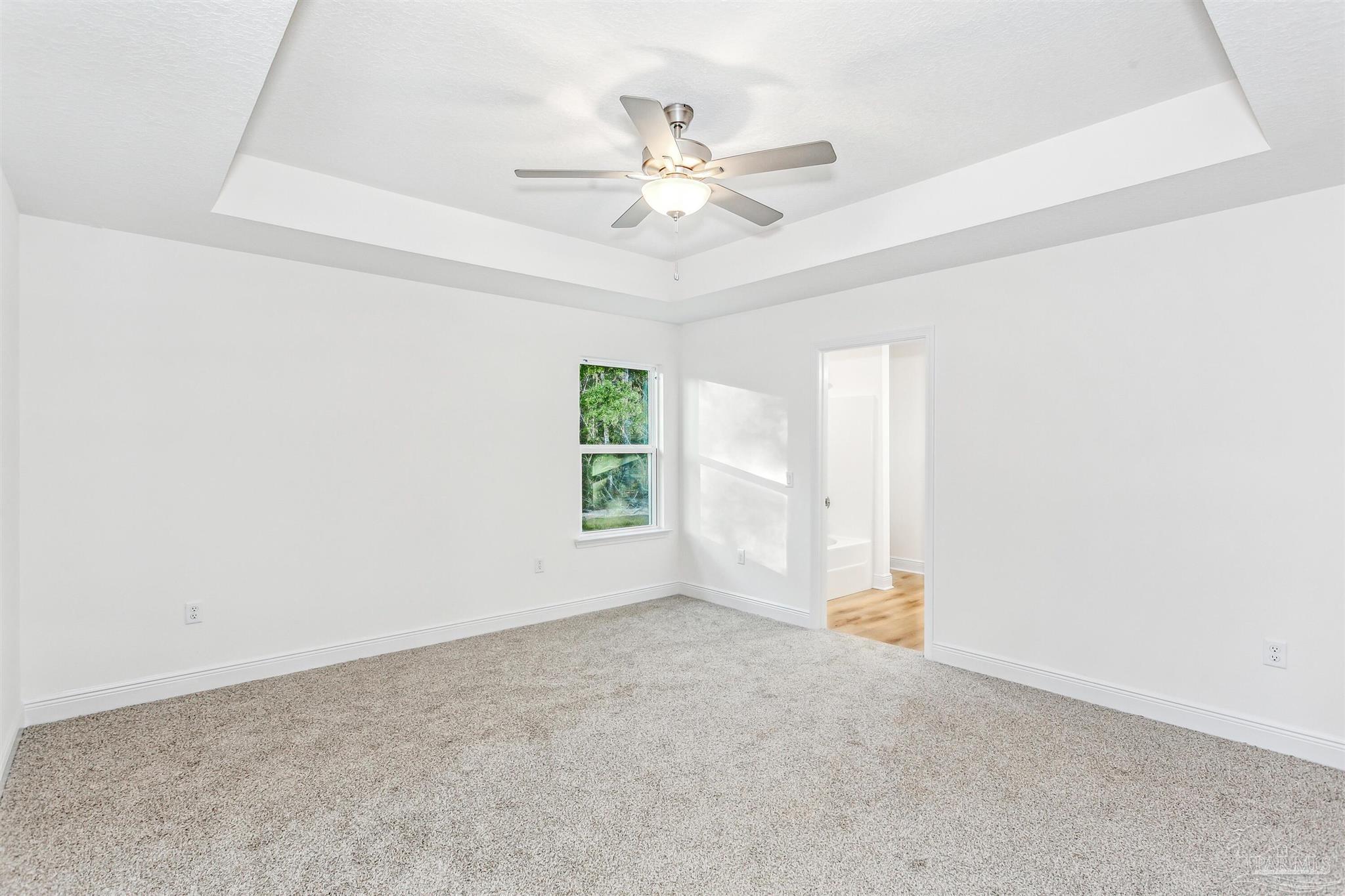 4613 Carl Booker Road Milton, FL 32583 - Photo 17 of 26 an empty room with a ceiling fan and window