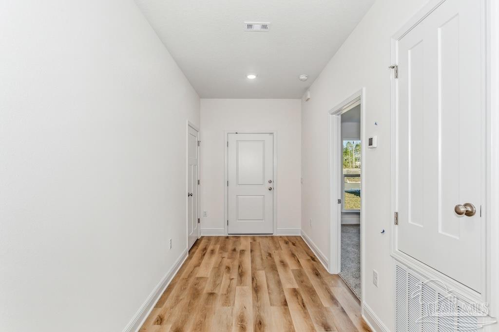 4613 Carl Booker Road Milton, FL 32583 - Photo 2 of 26 a view of a hallway with wooden floor and a bathroom