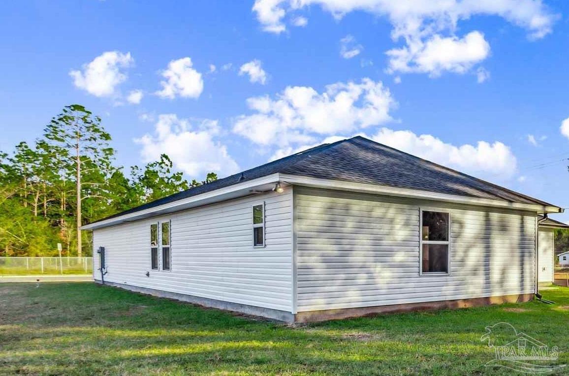 4613 Carl Booker Road Milton, FL 32583 - Photo 24 of 26 a view of a house with a yard