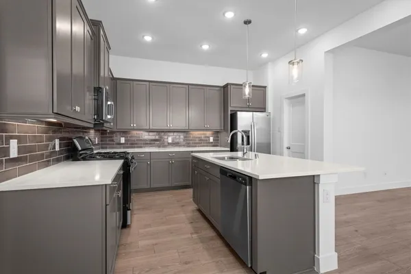 a kitchen with a sink stainless steel appliances and cabinets
