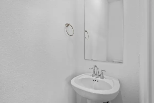a bathroom with a sink and mirror