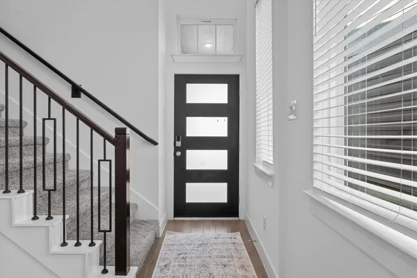 a view of entryway with stairs and wooden floor