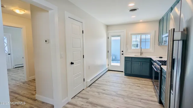 a kitchen with stainless steel appliances a refrigerator and a sink