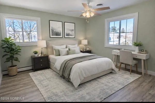 a bedroom with a large bed and a table chair
