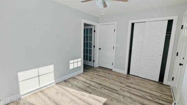 a view of an empty room and wooden floor