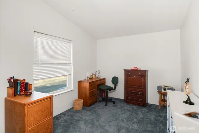 a workspace with furniture and window