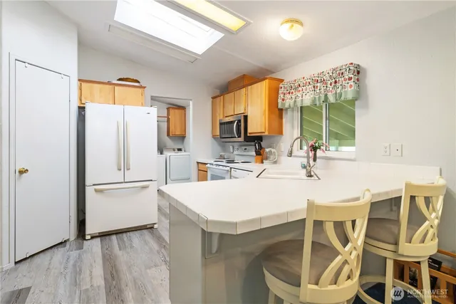 a kitchen with a table chairs and a refrigerator