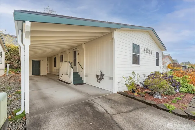 a view of a house with potted plants