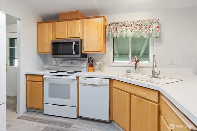 a kitchen with a sink stove and microwave