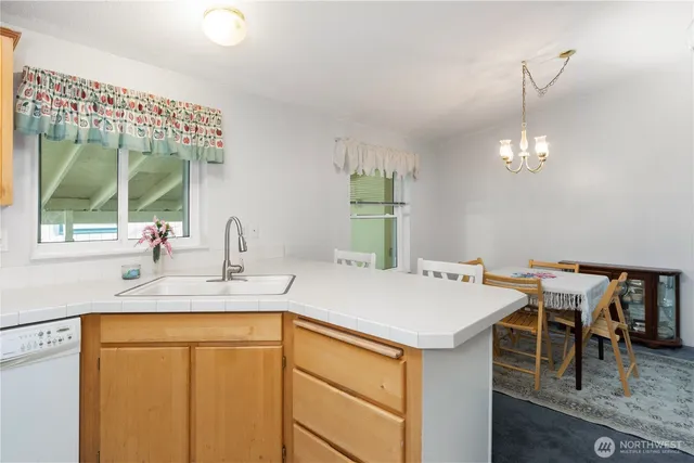 a kitchen with a table chairs and a wooden floor