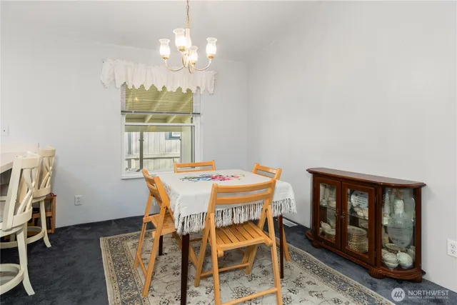 a dining room with furniture a rug and a chandelier