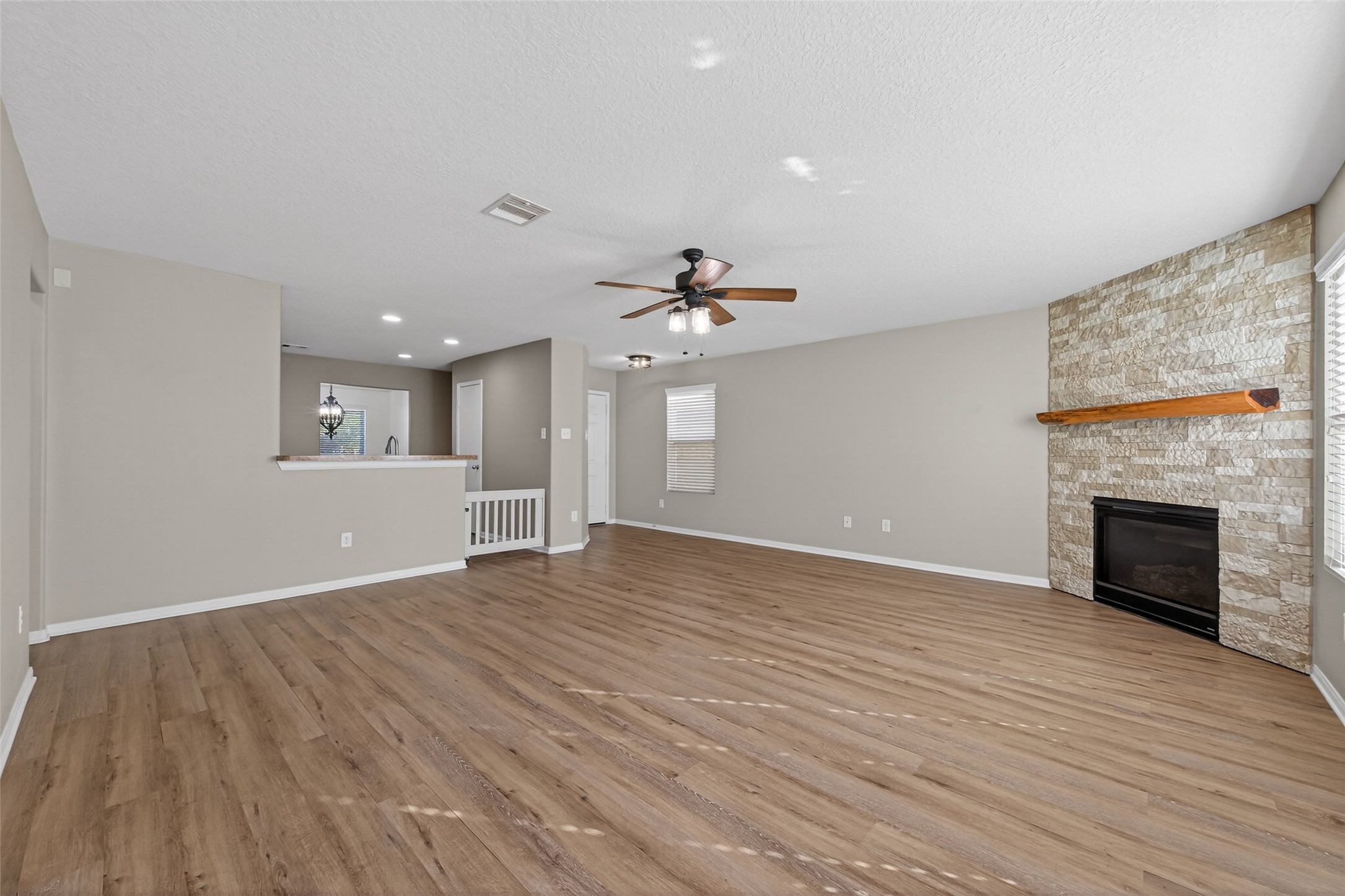 9940 Swallow Drive Conroe, TX 77385 - Photo 8 of 30 Custom gate to kitchen. Living room with energy efficient ceiling fan and custom gate to kitchen.