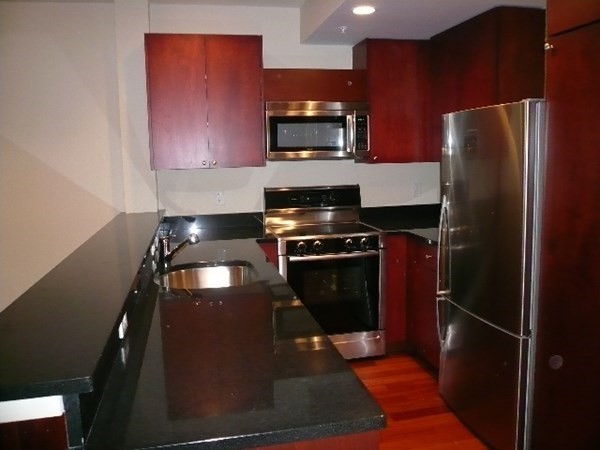 a kitchen with a refrigerator stove and microwave