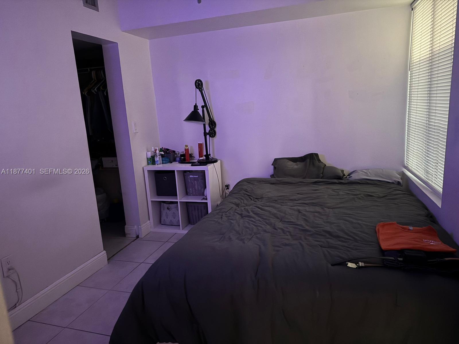 8205 Southwest 152nd Avenue, Unit F414 Miami, FL 33193 - Photo 9 of 13 a bed room with a bed and a window