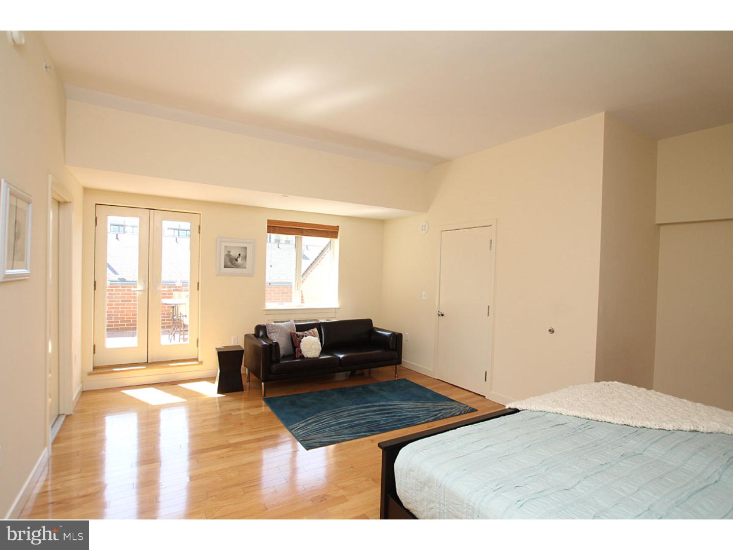 1900 Hamilton Street, Unit D19 Philadelphia, PA 19130 - Photo 12 of 25 a bedroom with a bed and wooden floor