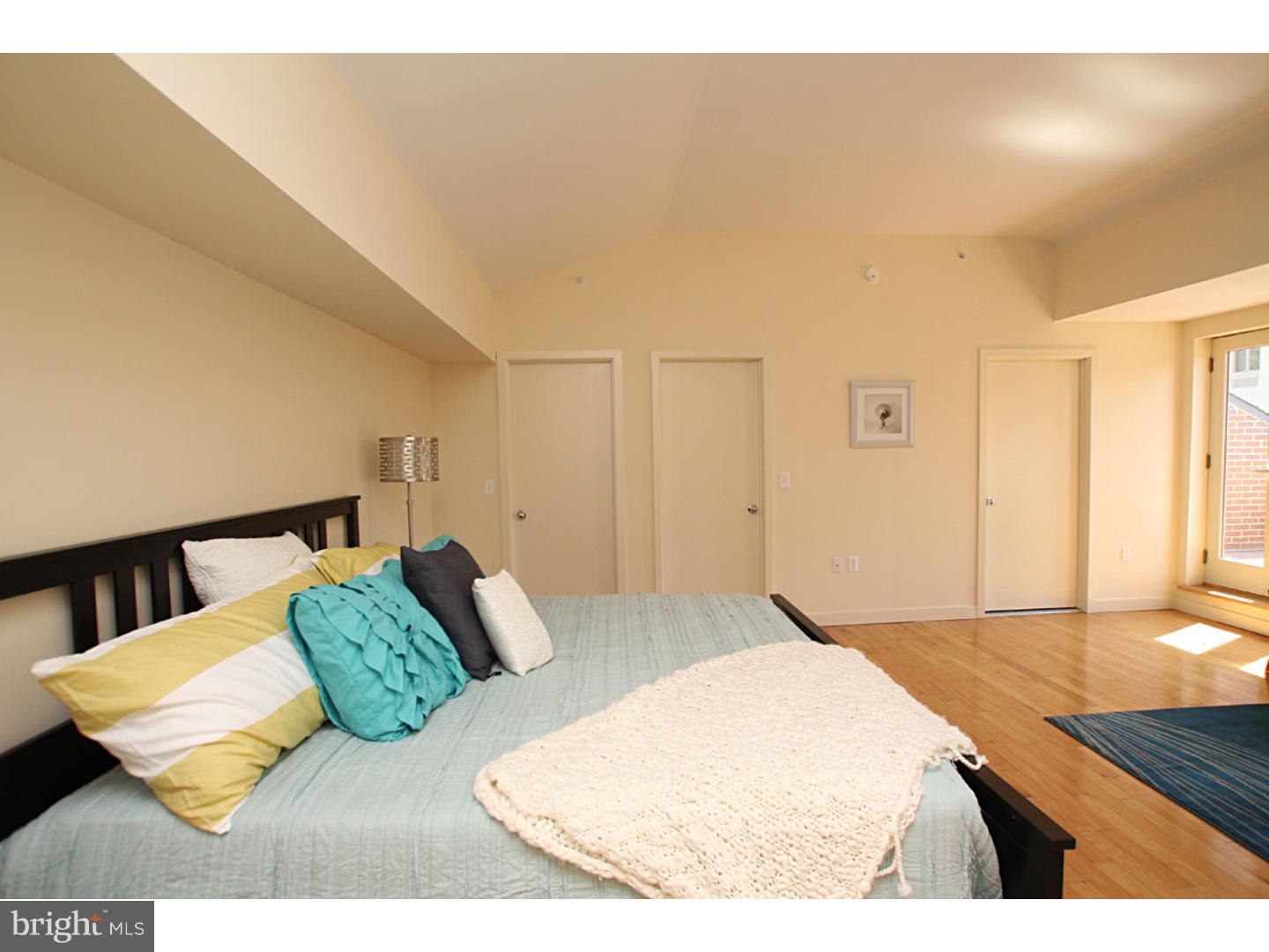 1900 Hamilton Street, Unit D19 Philadelphia, PA 19130 - Photo 13 of 25 a bedroom with a bed and a couch