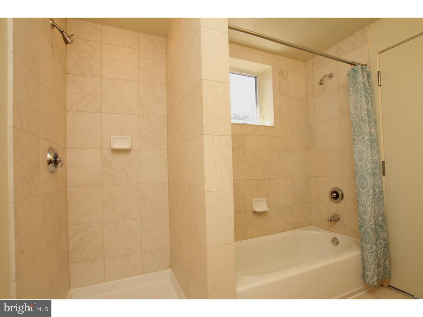 1900 Hamilton Street, Unit D19 Philadelphia, PA 19130 - Photo 17 of 25 a bathroom with a shower curtain and a sink