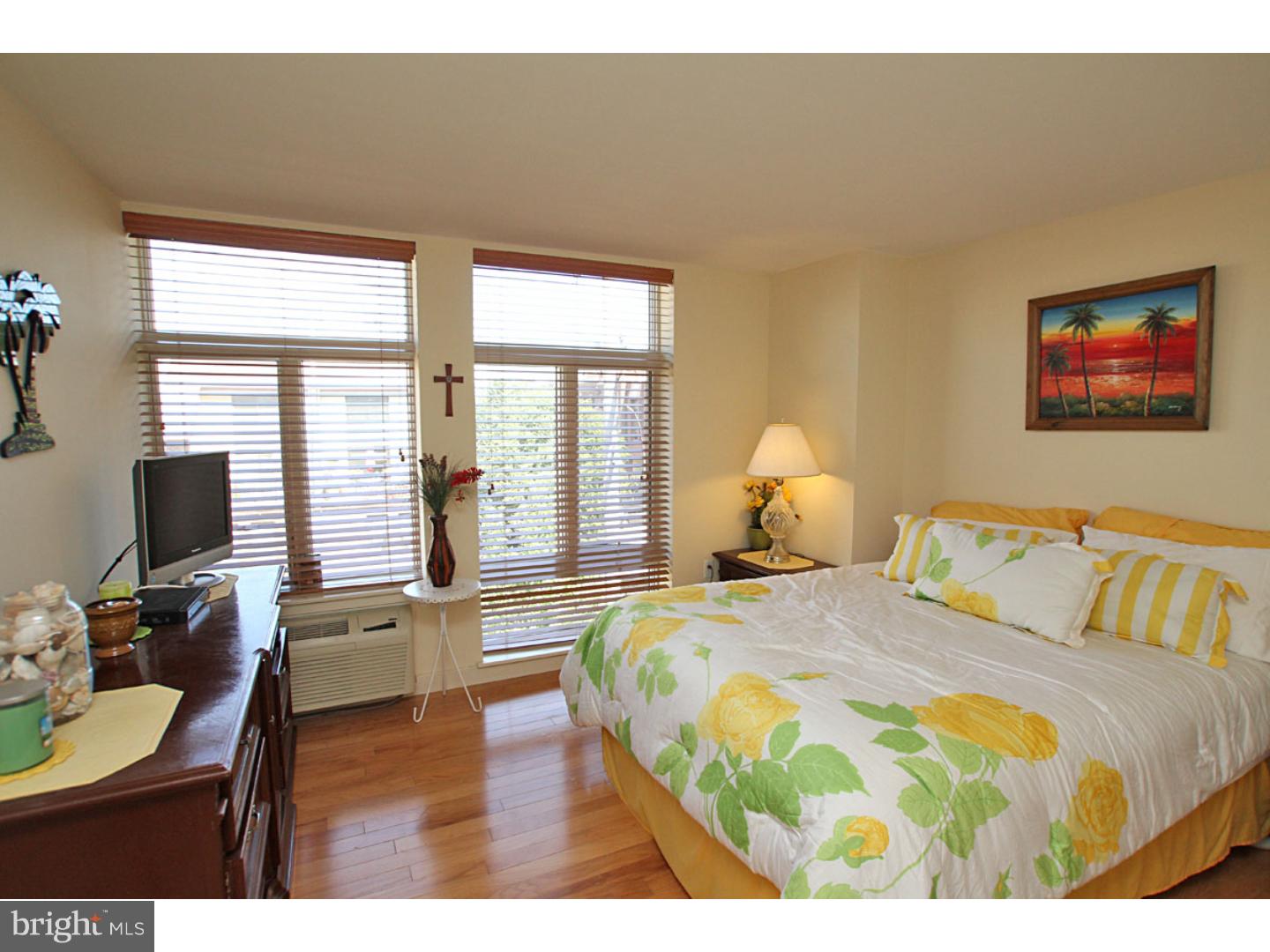 1900 Hamilton Street, Unit D19 Philadelphia, PA 19130 - Photo 18 of 25 a bedroom with a bed and wooden floor