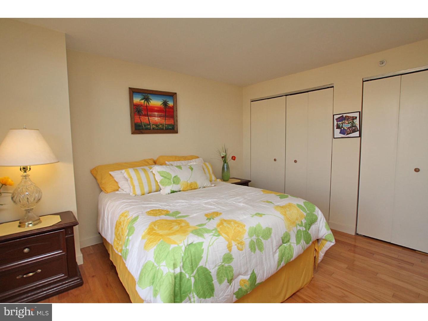 1900 Hamilton Street, Unit D19 Philadelphia, PA 19130 - Photo 19 of 25 a bedroom with a bed and a lamp on dresser