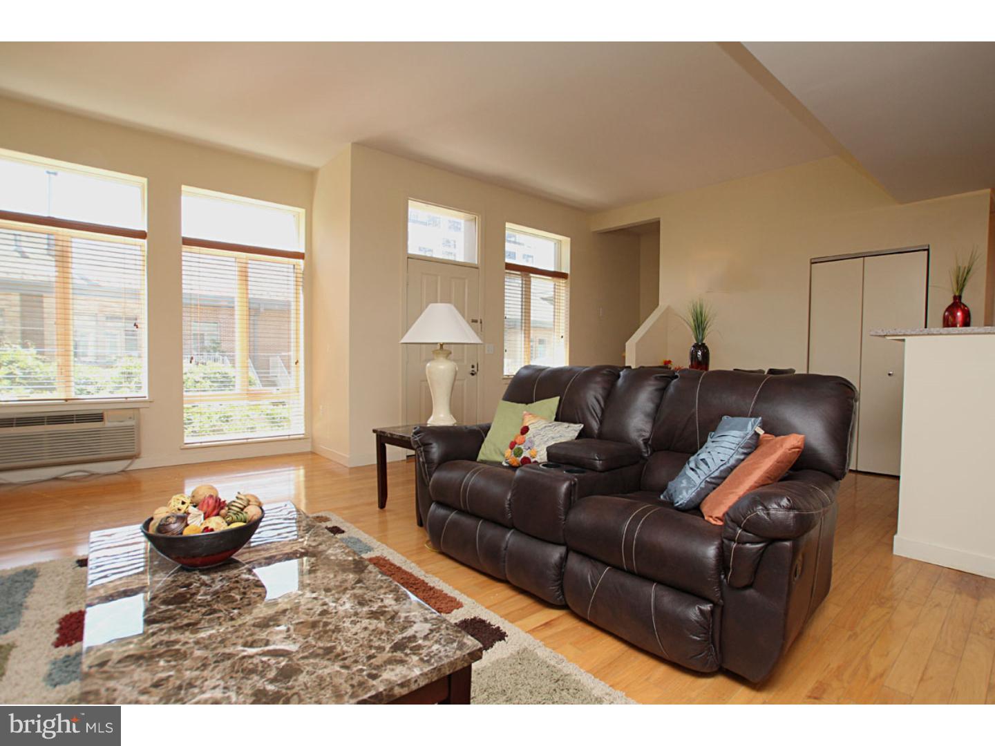 1900 Hamilton Street, Unit D19 Philadelphia, PA 19130 - Photo 3 of 25 a living room with furniture and a large window